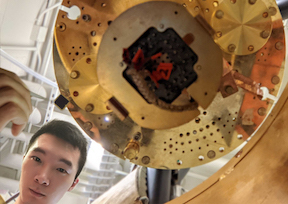 Zhiren (Isaac) Zheng holds up a sample of the new ferroelectric structure created by MIT researchers and colleagues