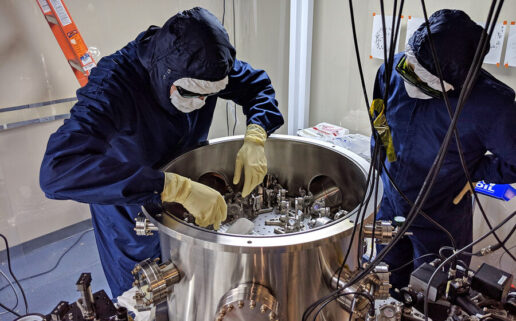 Physics Graduate Student Nicholas Demos (left) shows a mirror-testing apparatus to Satoshi Tanioka, a visiting student from Sokendai University.