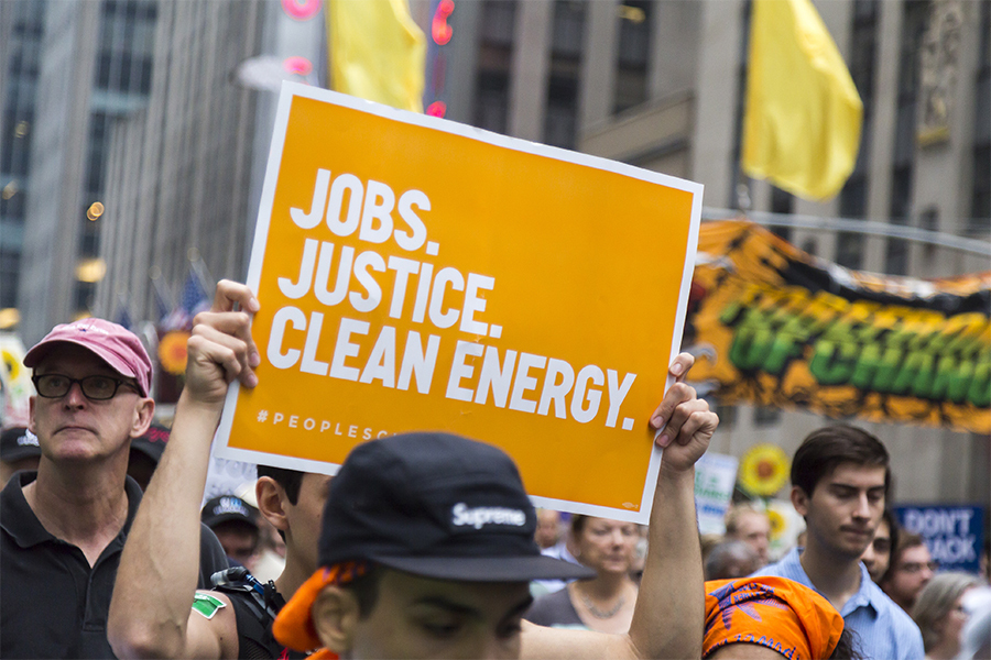 Photo from the March for Science showing a sign reading "Jobs, Justice, Clean Energy. #peoplesclimate"