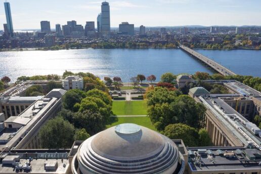 Aerial photo of the MIT dome and Killian Court facing the Charles River and Boston.