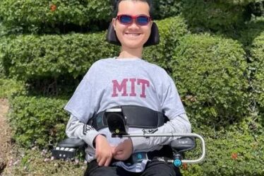 Undergraduate Ben Lou in motorized wheelchair wearing an MIT sweatshirt