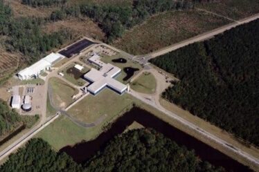 An aerial view of the Virgo site shows the Mode-Cleaner building, the Central building, the 3km-long west arm and the beginning of the north arm.