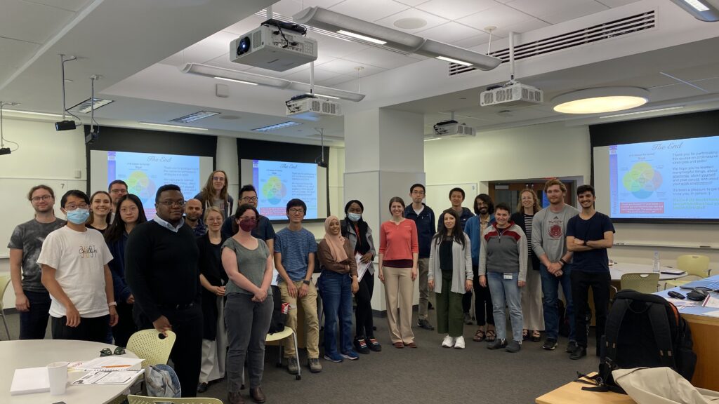 students pose with professor for last class photo